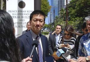 Hawaii Attorney General Douglas Chin speaks outside federal court in Honolulu, Wednesday, March 29, 2017.