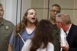 Jeremy Joseph Christian shouts as he is arraigned in Multnomah County Circuit Court in Portland, Ore., Tuesday, May 30, 2017.