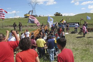 In this Aug.  12, 2016, file photo, Native Americans protest the Dakota Access oil pipeline near the Standing Rock Sioux reservation in southern North Dakota.