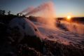 Dawn breaks at Perisher on Thursday as snow guns prepare for the opening of the season.