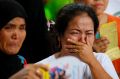 Displaced residents of Marawi cry upon receiving assurance of support from local officials at an evacuation centre in ...