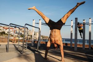 A man enjoys the autumn sun at Bondi Beach while exercising on the open air gymnasium equipment, on May 17, 2017 in ...