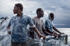 Refugees and migrants are seen on board the Migrant Offshore Aid Station (MOAS) 'Phoenix' vessel as they approach Italy ...