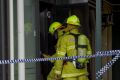 Fire crews and police investigate the alleged arson at the Brierly Street cafe in Weston in March 2014.