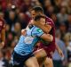 Lung-busting: Brett Morris is tackled during the frenetic opener to the State of Origin series.