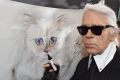Karl Lagerfeld with a painting of his beloved cat Choupette.