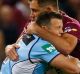 Lung-busting: Brett Morris is tackled during the frenetic opener to the State of Origin series.