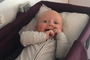 Baby Gabriel enjoying his bassinet on the plane.