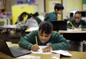 In this Feb. 23, 2017 photo, Justin Langloise, 8, works on a project in his third-grade classroom at the Martin Luther King Jr. Elementary School in Hartford, Conn.