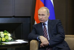 Russian President Vladimir Putin listens to Palestinian President Mahmoud Abbas at the Bocharov Ruchei residence in the Black Sea resort of Sochi, Russia, Thursday, May 11, 2017.