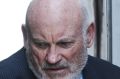 Ian Macdonald is led into the Supreme Court on Friday to be sentenced. 