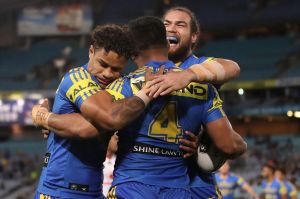 Quick opener: Josh Hoffman and Tepai Moeroa celebrate with Kirisome Auva'a after the centre's early try.