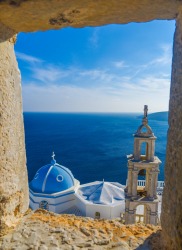 Panagia Portaitissa monastery viewed from a window of Querini's Venetian Castle, Astypalea Island, Greece.After taking ...