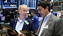 Traders James Riley, left, and Mark Muller work on the floor of the New York Stock Exchange, Friday, May 26, 2017. ...