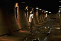 A tourist walks through underground tunnels constructed during World War II.