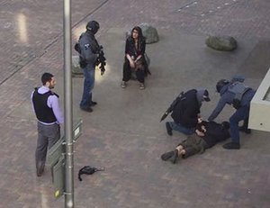 A person, on ground, being detained by police at Elizabeth Fry apartments in Barking, east London, which officers raided Sunday June 4, 2017, following Saturday's terror attack at London Bridge and Borough Market.