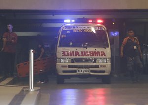 Rescue workers carry a stretcher inside a hotel at the Resorts World Manila complex, early Friday, June 2, 2017, in Manila, Philippines.