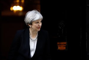 Britain's Prime Minister Theresa May walks to welcome Ukraine's President Petro Poroshenko prior to their talks, at 10 Downing Street in London, Wednesday, April 19, 2017.