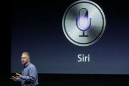 FILE - In this Oct. 4, 2011, file photo, Apple's Phil Schiller talks about Siri during an announcement at Apple headquarters in Cupertino, Calif. Apple�s Siri made a big splash when the wisecracking digital assistant debuted in 2011. But as its competitors jockey to build intelligent �chat bots� and voice-controlled home systems capable of more challenging artificial-intelligence feats, Siri at times no longer seems cutting edge. On Monday, June 13, 2016, Apple is expected to demonstrate how much smarter Siri can get as it kicks off its annual software conference. It�s a potentially momentous time for the company; sales of its flagship iPhone are slowing, and AI is emerging as a key tech battleground.  (AP Photo/Paul Sakuma, File)