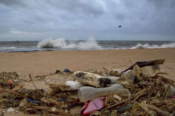FILE- In this Aug. 13, 2015, file photo, a plastic bottle lies among other debris washed ashore on the Indian Ocean beach in Uswetakeiyawa, north of Colombo, Sri Lanka. Secretary-General Antonio Guterres  on Monday, June 5, 2017, opened the first-ever U.N. conference on oceans with a warning that the lifeblood of the planet is "under threat as never before," with one recent study warning that discarded plastic garbage could outweigh fish by 2050 if nothing is done.