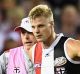 Nick Riewoldt of the Saints is helped onto the stretcher after hurting his knee.