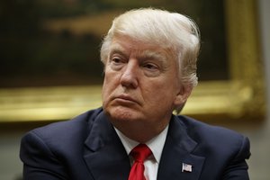 President Donald Trump listens during a meeting with the National Association of Manufacturers in the Roosevelt Room of the White House, Friday, March 31, 2017, in Washington.