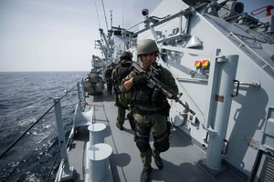 SOUTH CHINA SEA (June 20, 2013) A visit, board, search and seizure team from Surface Warfare Detachment 1, embarked aboard the littoral combat ship USS Freedom (LCS 1) searches and secures the Royal Malaysian Navy guided-missile frigate KD Jebat (FFG 29)during a Cooperation Afloat Readiness and Training (CARAT) Malaysia 2013 exercise.