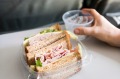 Turkey sandwich on an airplane seat tray.