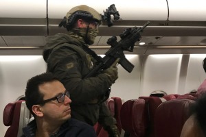 Heavily armed police boarded the plane after it returned to Melbourne.