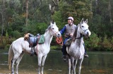 Gem Farm’s Jeremy Ford helps riders cross a river.