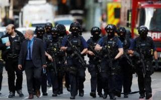 Armed police in balaclavas walk through Borough Market