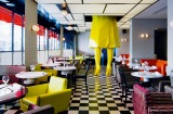Xavier Veilhan's Sophie sculpture drops through the ceiling from the private bar above Germain, designed by India Mahdavi. 