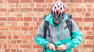 A Deliveroo driver in the current uniform, which is becoming a popular eBay item due to its highly reflective fabric. 