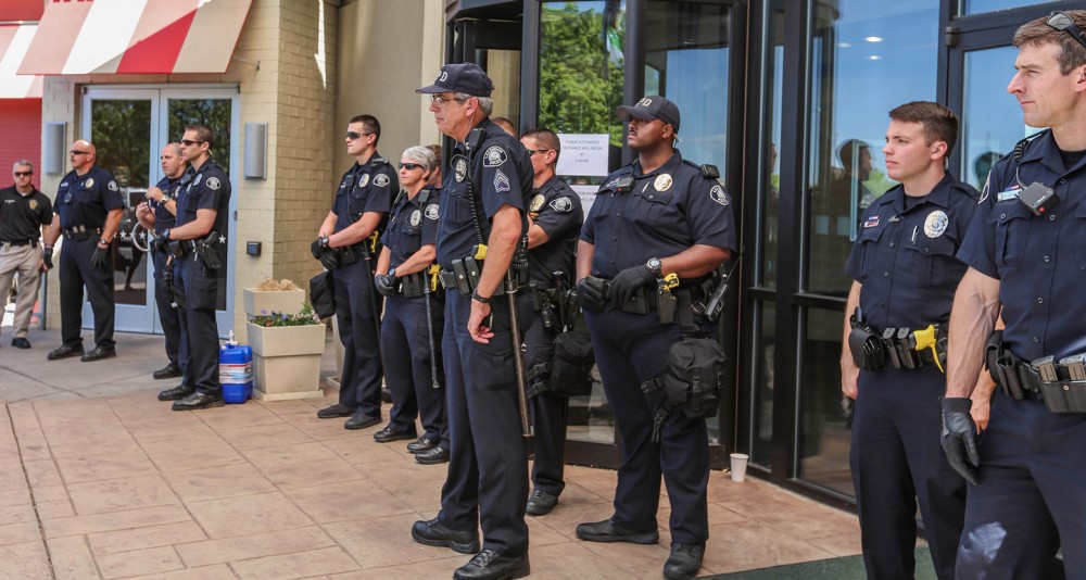 Police officers block the entrance to the Bureau of Land Management auction at the Holiday Inn of Lakewood, Colorado, May 12, 2016. Photo: Olivia Abtahi/Survival Media Agency