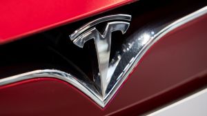 Tesla Inc. badge is displayed on the front grille of Model S 90D electric vehicle at the company's showroom in Hanam, ...