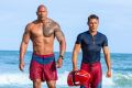 Buff daddy: Dwayne Johnson and Zac Efron in the movie reboot of  Baywatch. 