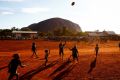 Children playing footy during the closing ceremony in the Mutitjulu community of the First Nations National Convention ...