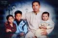 Asghar Ali with his three children, who live in Pakistan.