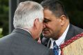 Rex Tillerson is greeted with a hongi by Parliamentary kaumatua Kura Moeahu and Defence Minister Gerry Brownlee on Tuesday.