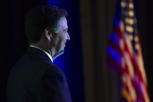 FBI Director James Comey waits to go onstage to adddress the Intelligence and National Security Alliance Leadership Dinner in Alexandria, Va.