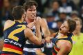 Cop that: The Crows' Matt Crouch reacts after a jumper punch from 200-game Cat Tom Hawkins.