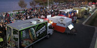 Mobile food vending trucks on a busy foreshore