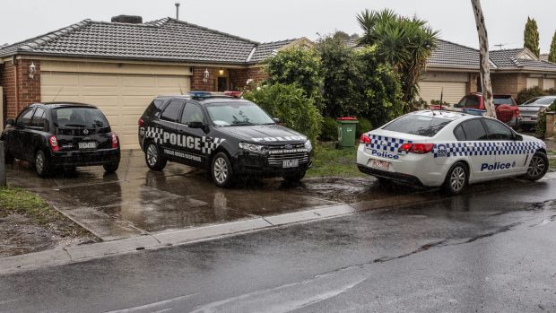 Police at the house where Khayre is believed to have lived with his mother and brothers.