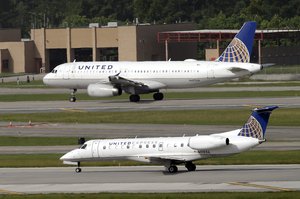 In this July 8, 2015, file photo, United Airlines and United Express planes prepare to takeoff at George Bush Intercontinental Airport in Houston.