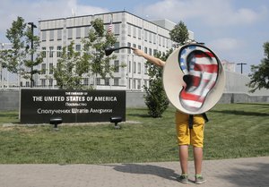 An activist of Ukraine's Internet party gestures as he demands the American authorities stop the pursuit of National Security Agency leaker Edward Snowden at an action of protest near the US Embassy in Kiev, Ukraine, Thursday, June 27, 2013.