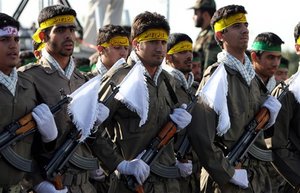 ** FILE ** Militias of Iran's Revolutionary Guards (Basiji) parade as they have headbands sign: Great Allah, There is no god but Allah, Muhammad is his messenger,(tmg1)