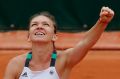 Romania's Simona Halep raises her fist as she defeats Russia's Daria Kasatkina during their third round match of the ...