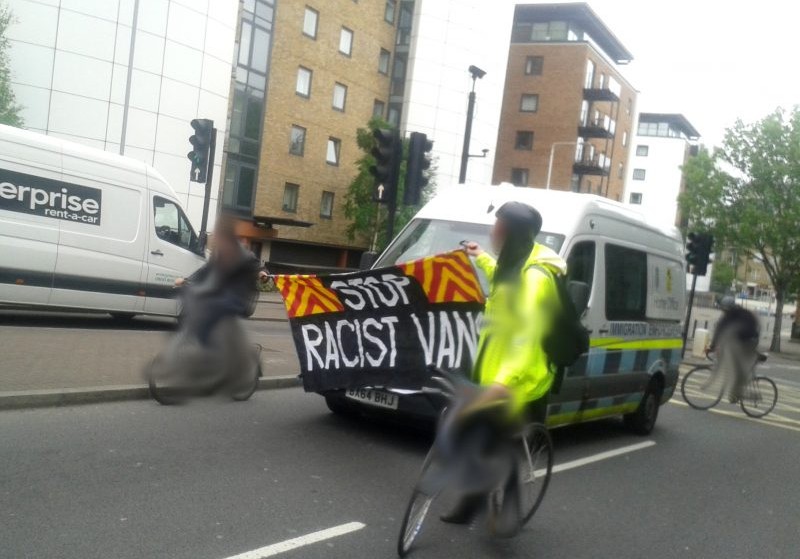 Cyclists surrounding an immigration enforcement van