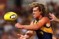 West Coast's Matt Priddis fires off a handball just in time.