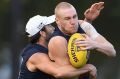 Jordan Lewis tackles Tom McDonald at training on Tuesday.